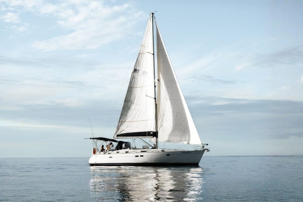 Luxury sailing yacht sailing with deployed sails in the ocean.