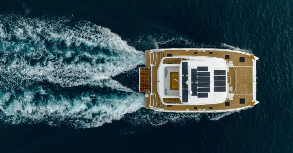 Omaya 50 Power Catamaran exterior view highlighting its massive 27-foot (8.4m) beam and fuel-efficient hull design for long-range cruising.